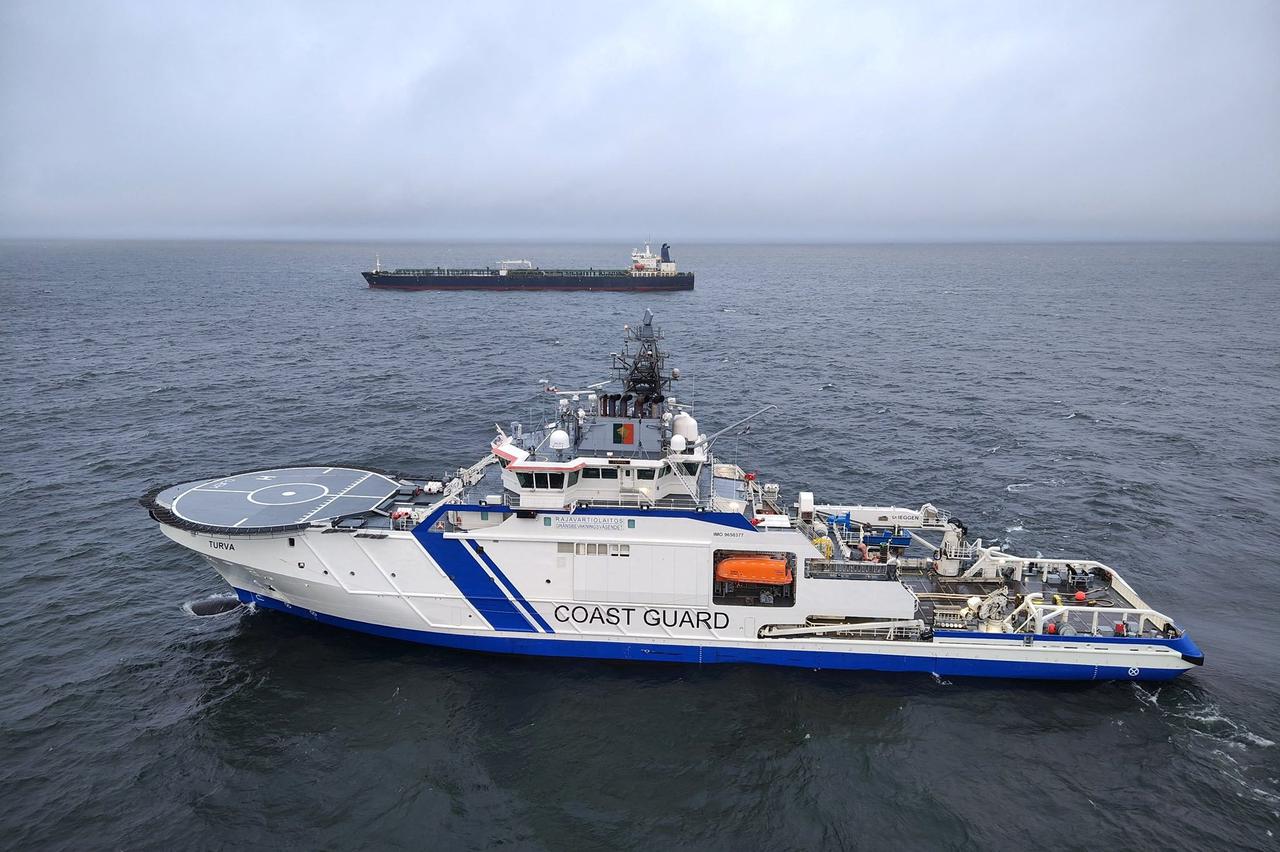 Finnish Border Guard's ship Turva and oil tanker Eagle S sail on the sea outside the Porkkalanniemi, Finland