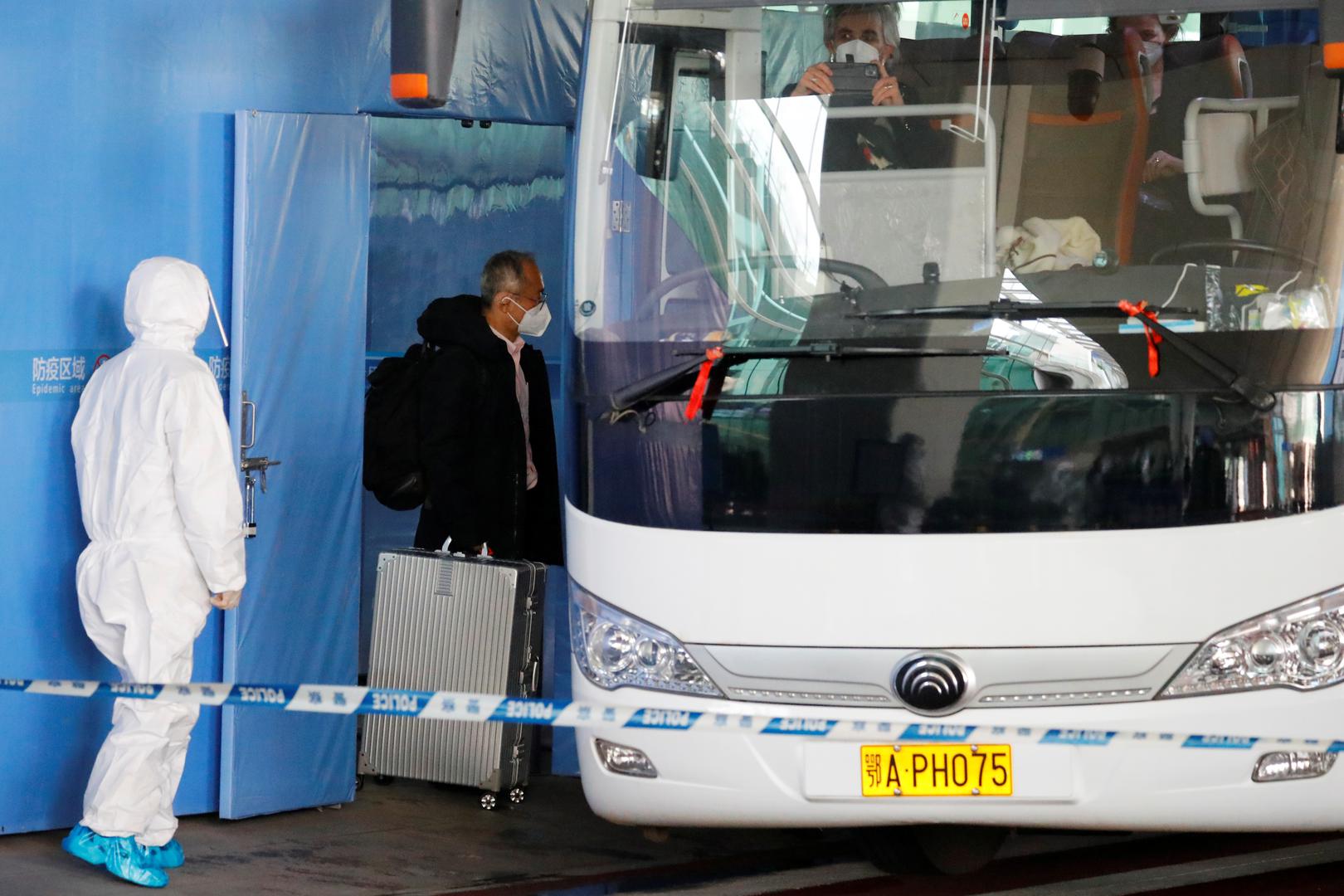 Members of the WHO team tasked with investigating the origins of the coronavirus disease (COVID-19) pandemic in Wuhan Members of the World Health Organisation (WHO) team tasked with investigating the origins of the coronavirus disease (COVID-19) pandemic board a bus before leaving Wuhan Tianhe International Airport in Wuhan, Hubei province, China January 14, 2021. REUTERS/Thomas Peter THOMAS PETER