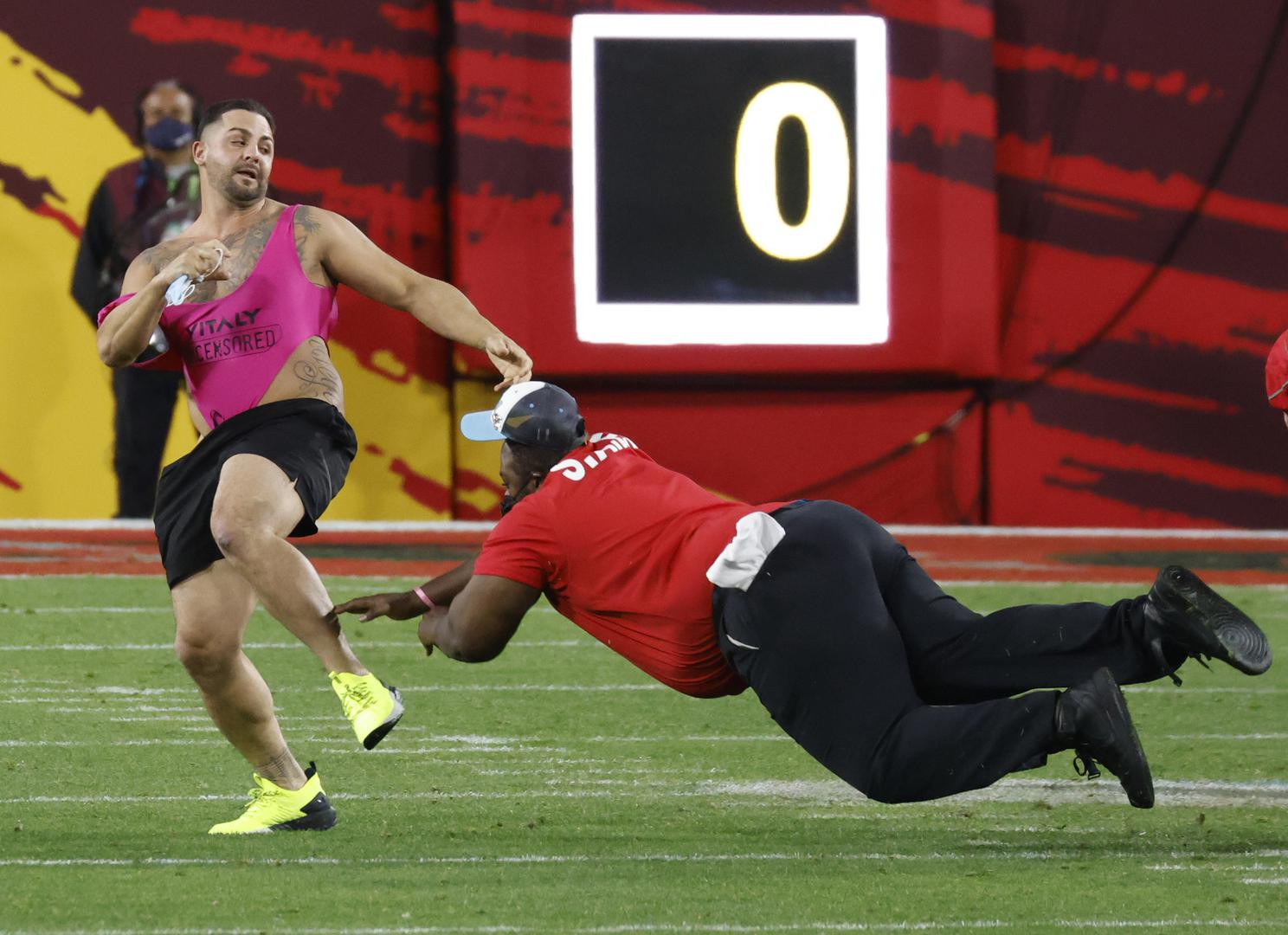 A fan is tackled by security personnel as he runs on to the field during the fourth quarter of Super Bowl LV at Raymond James Stadium in Tampa, Florida on Sunday, February 7, 2021.   Photo by John Angelillo/UPI Photo via Newscom Newscom/PIXSELL
