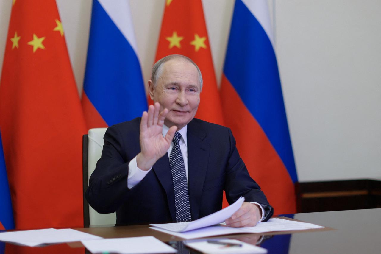 Russian President Vladimir Putin holds a video conference meeting with Chinese President Xi Jinping, outside Moscow