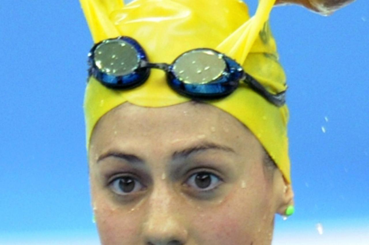 '(FILES) Australia\'s Stephanie Rice takes of her cap after her victory in the women\'s 400m individual medley swimming final at the National Aquatics Center in the 2008 Beijing Olympic Games on Augus