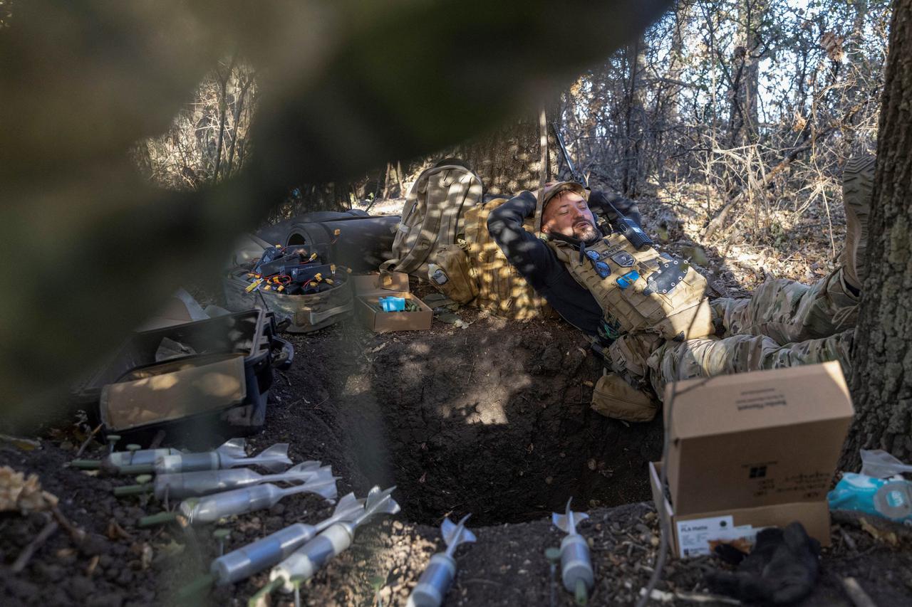 Ukrainian serviceman rests at a position near a front line in Kharkiv region