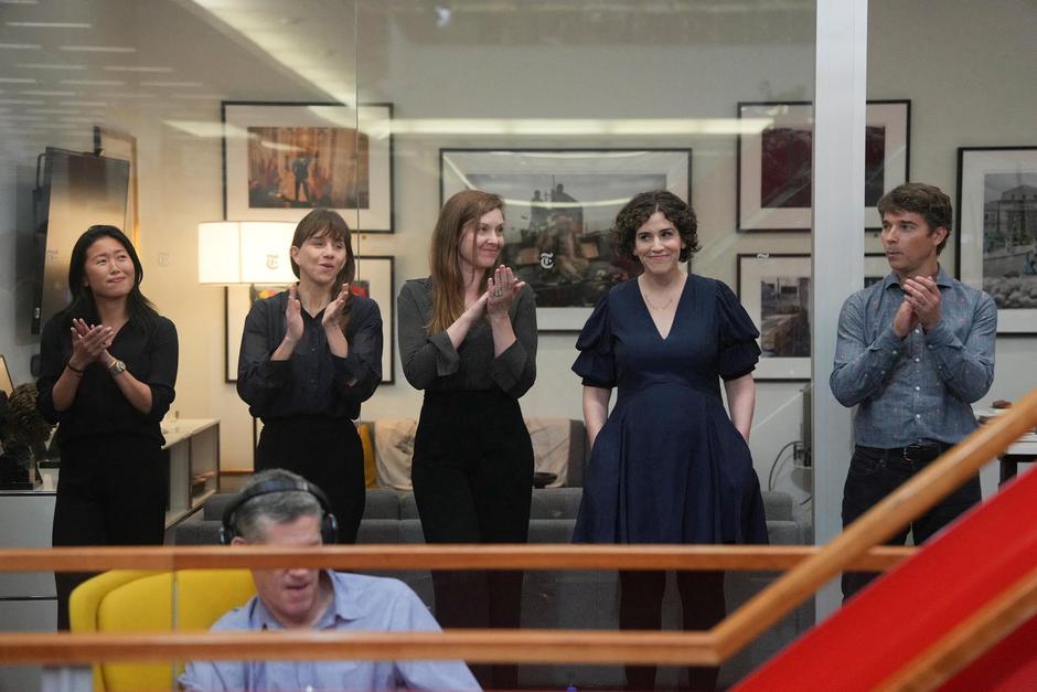 Hannah Dreier reacts as colleagues applaud during a Pulitzer Prize gathering in the newsroom of The New York Times