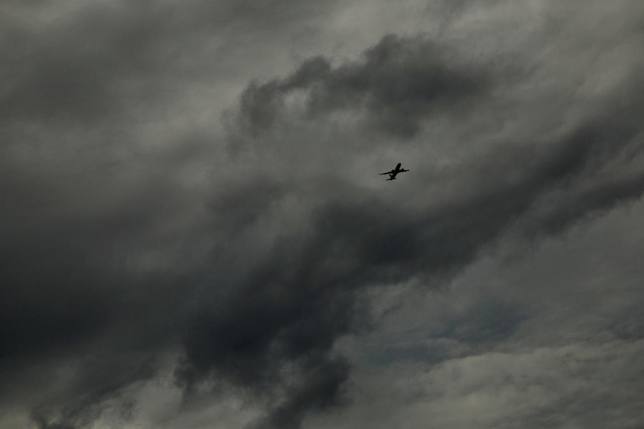 A plane flies before the arrival of Hurricane Milton, in Orlando