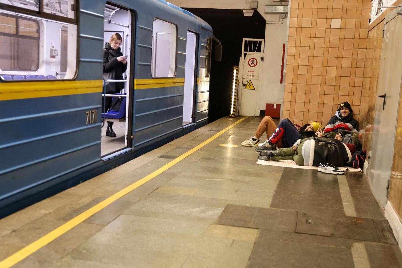 People gather at a metro station as they seek shelter from expected Russian air strikes, in Kyiv