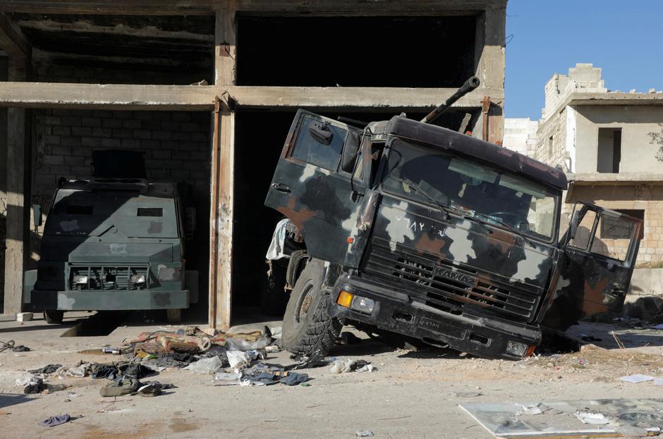 A damaged military vehicle lies in the city of Maraat al-Numan, in Idlib province