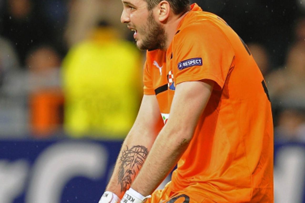 'Dinamo Zagreb\'s goalkeeper Ivan Kelava reacts after conceding a goal to Real Madrid during their Champions League Group D soccer match at Santiago Bernabeu stadium in Madrid November 22, 2011.  REUT