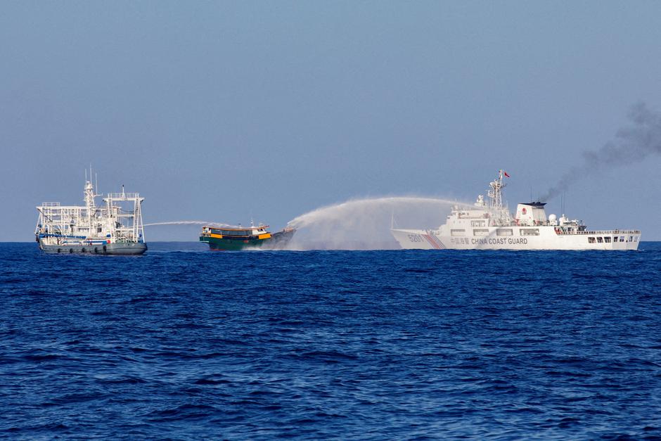 FILE PHOTO: Chinese Coast Guard vessels fire water cannons towards a Philippine resupply vessel Unaizah May 4 on its way to a resupply mission at Second Thomas Shoal in the South China Sea