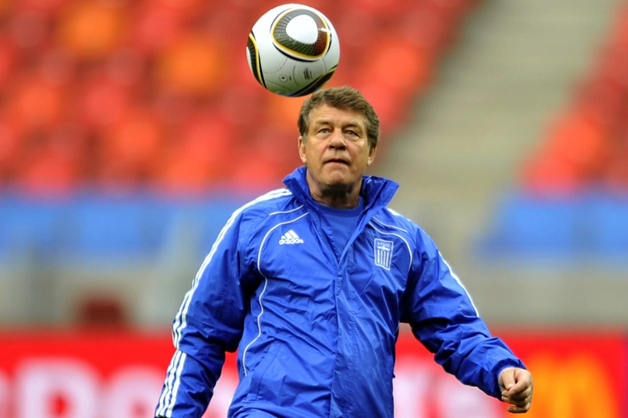 'Greece\'s coach Otto Rehhagel eyes the ball during a training session at the Nelson Mandela Bay stadium in Port Elizabeth on June 11, 2010 on the opening day of the 2010 World Cup. Africa\'s first Wo