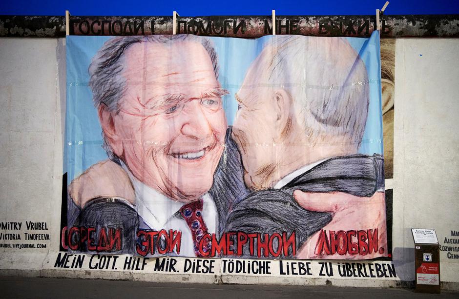 Former German Chancellor Schroeder and Russian President Putin are depicted in this graffiti exchanging a kiss at Berlin's East Side Gallery