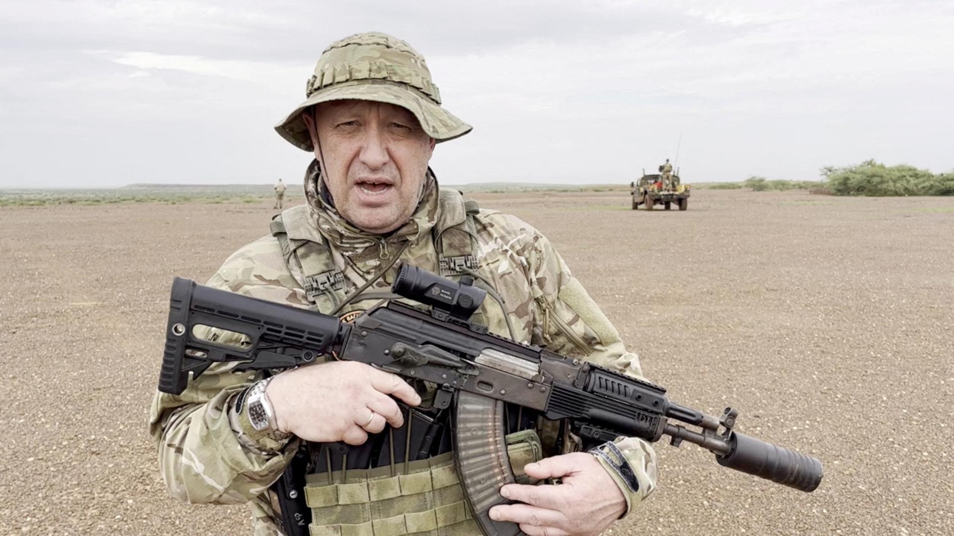 Yevgeny Prigozhin, chief of Russian private mercenary group Wagner, gives an address in camouflage and with a weapon in his hands in a desert area at an unknown location, in this still image taken from video possibly shot in Africa and published August 21, 2023. Courtesy PMC Wagner via Telegram via REUTERS ATTENTION EDITORS - THIS IMAGE WAS PROVIDED BY A THIRD PARTY. NO RESALES. NO ARCHIVES. MANDATORY CREDIT.     TPX IMAGES OF THE DAY Photo: PMC WAGNER/REUTERS