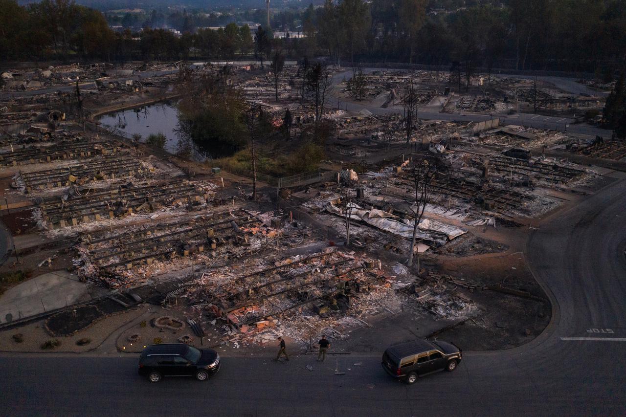 Security officials survey neighborhood left devastated by the Almeda fire in Phoenix, Oregon