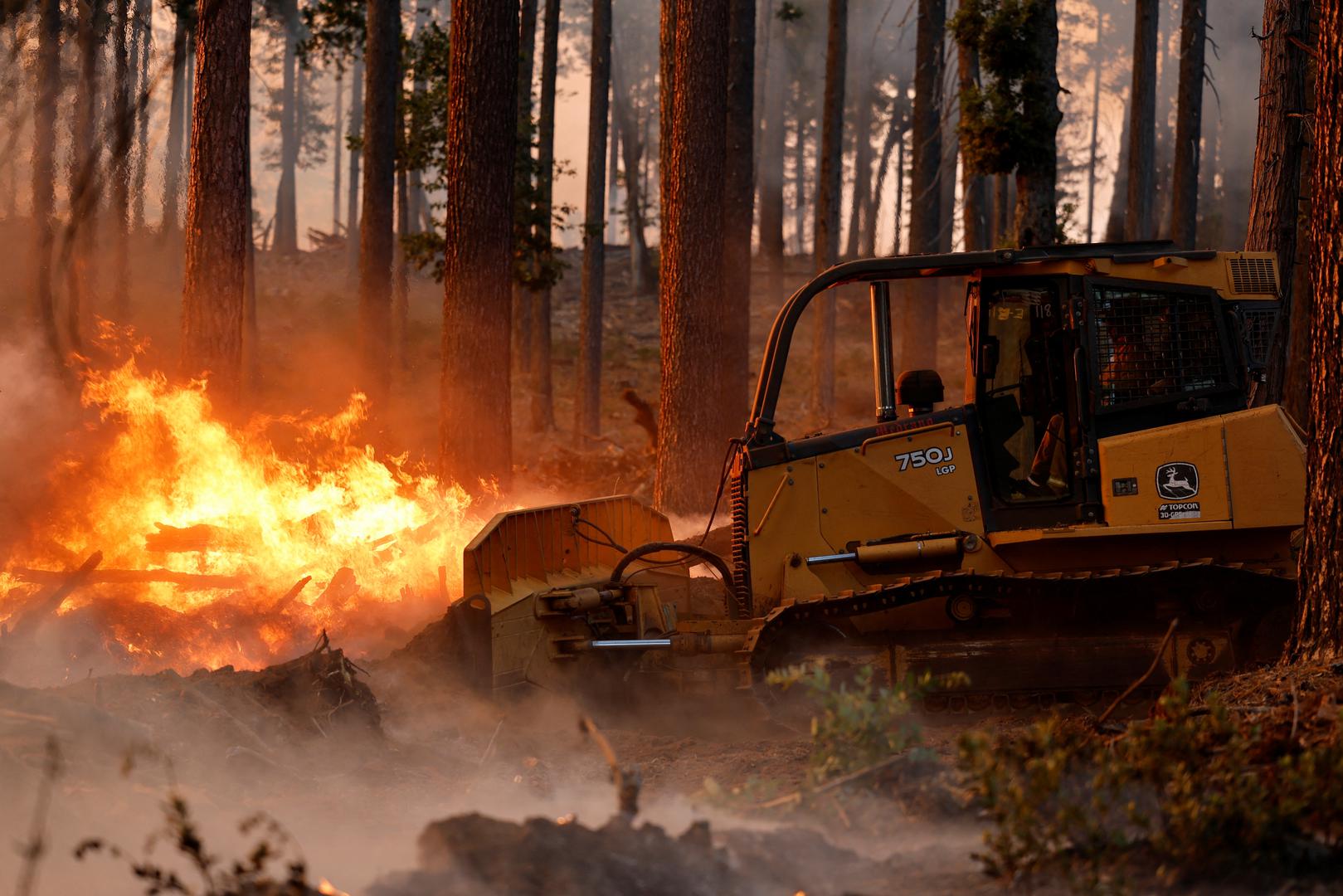 A bulldozer is used to put out flames along Highway 32 near Forest Ranch, California, U.S. July 26, 2024. REUTERS/Fred Greaves Photo: FRED GREAVES/REUTERS