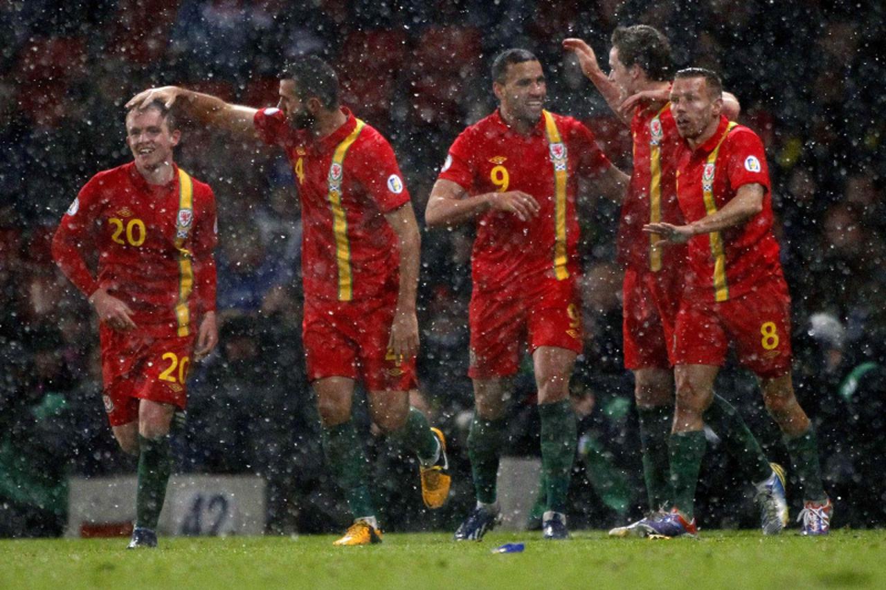'Wales\' Hal Robson-Kanu (3rd R) celebrates with his team mates after scoring a penalty kick against Scotland during their 2014 World Cup qualifying soccer match at Hampden Park stadium in Glasgow, Sc