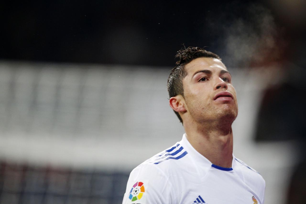 'Real Madrid's Cristiano Ronaldo reacts after missing an opportunity to score against Malaga during their Spanish first division soccer match at Santiago Bernabeu stadium in Madrid March 3, 2011.  RE