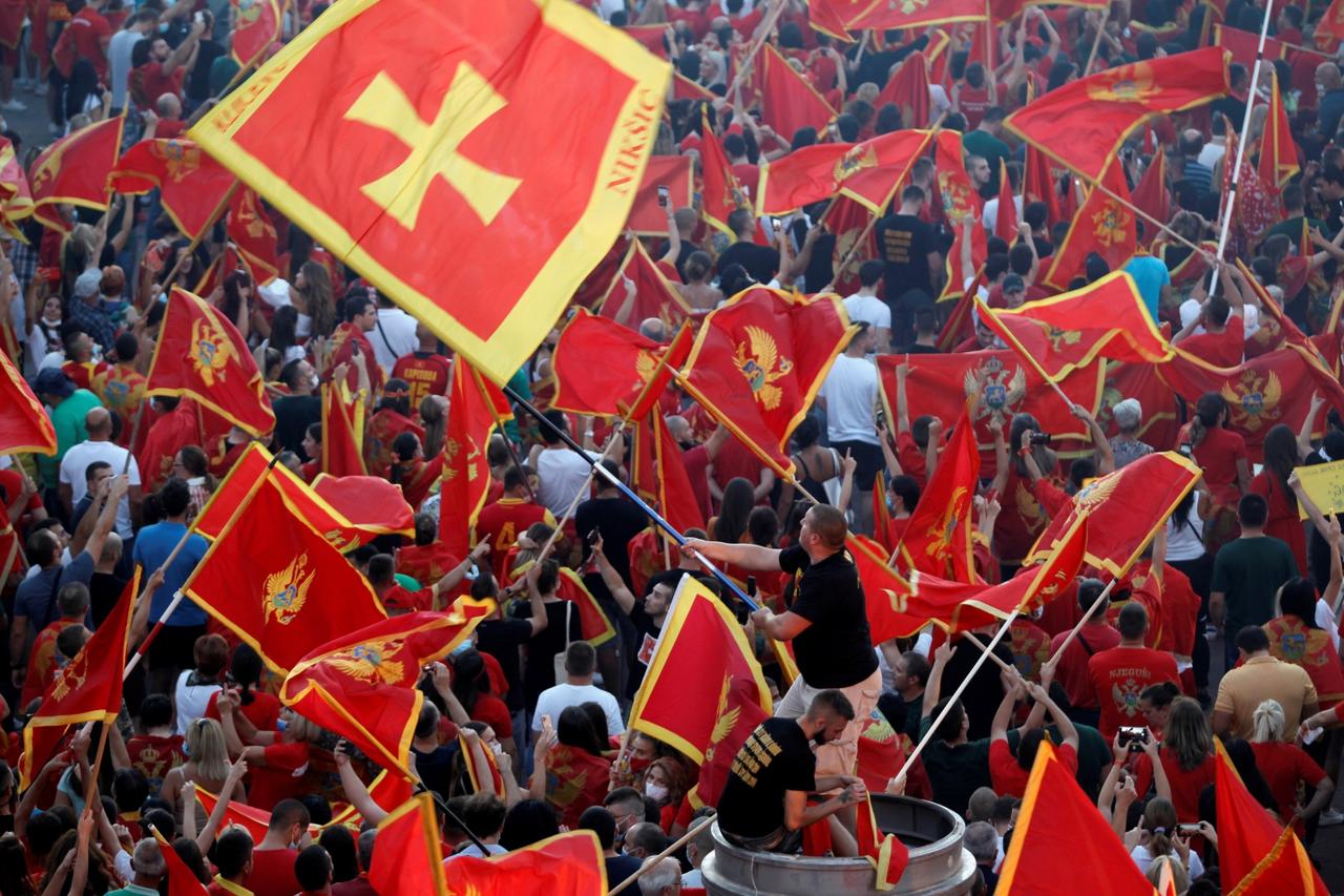 Self-described patriots wave flags during post-election rally in Podgorica