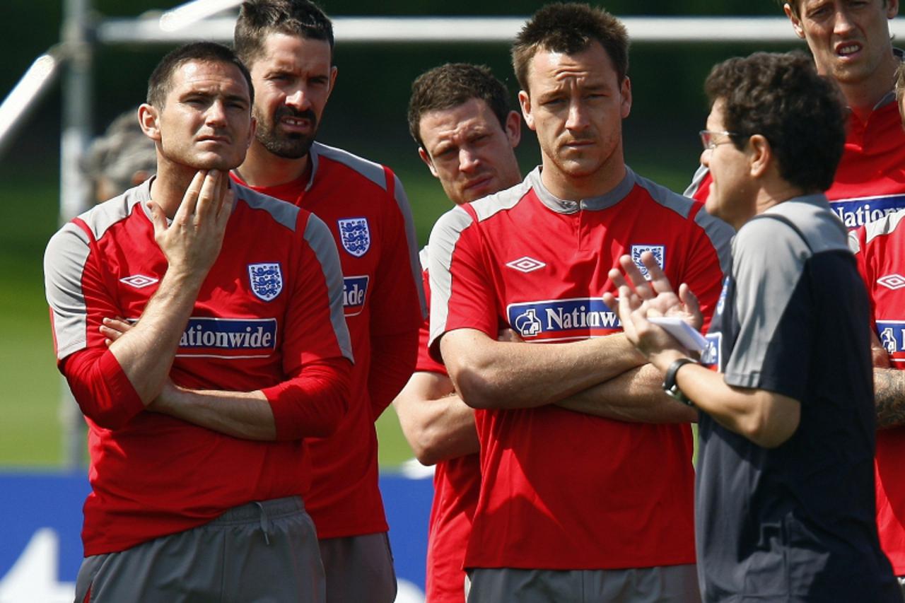 'England manager Fabio Capello (R) talks to Frank Lampard (L) and John Terry (2nd R) during a team soccer training session in London Colney, north of London June 1, 2009. England are due to play Kazak