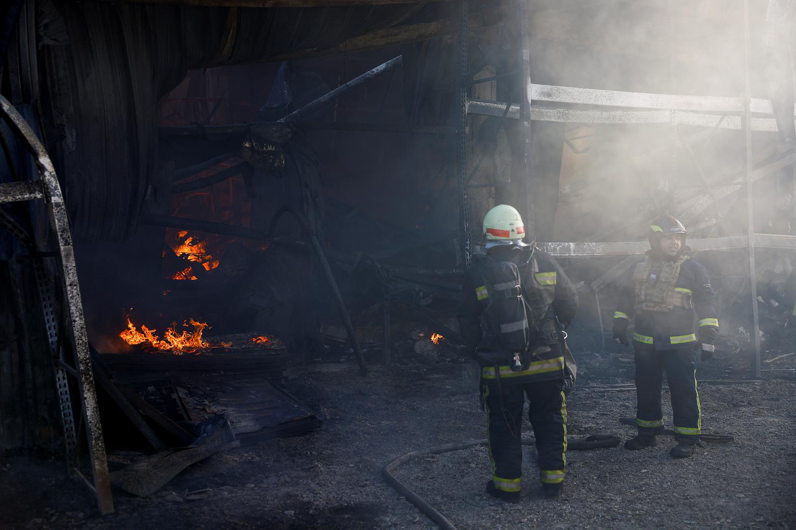 Firefighters work at the site of a household item shopping mall which was hit by a Russian air strike, amid Russia's attack on Ukraine, in Kharkiv, Ukraine, May 25, 2024. REUTERS/Valentyn Ogirenko Photo: VALENTYN OGIRENKO/REUTERS