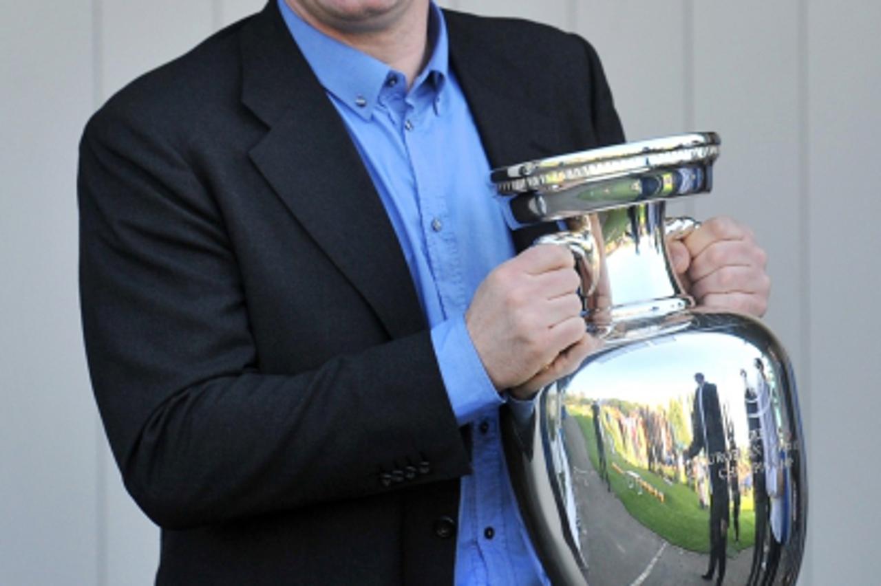 'Davor Suker, former footballer and UEFA ambassador, carries a EURO 2012 tournament cup during meeting with young Ukrainian football players in Kiev on May 11, 2012.   Along with tournament co-hosts P