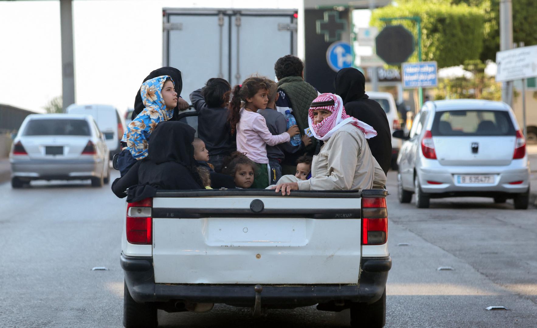 Internally displaced people, who fled from their southern Lebanon villages due to ongoing cross-border hostilities between Hezbollah and Israeli forces, ride on a pick up truck in Beirut, Lebanon September 24, 2024.  REUTERS/Mohamed Azakir Photo: MOHAMED AZAKIR/REUTERS