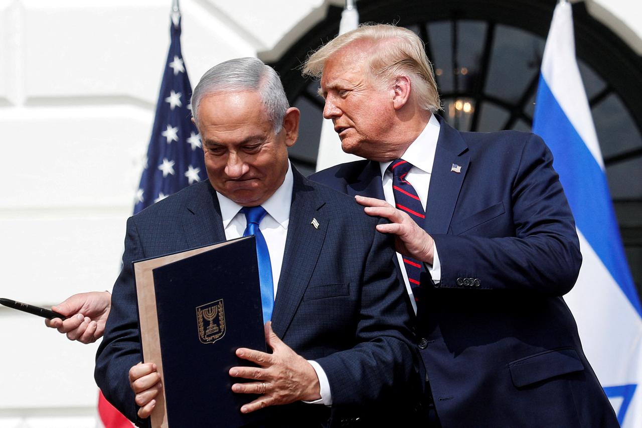 Israel's Prime Minister Benjamin Netanyahu stands with U.S. President Donald Trump