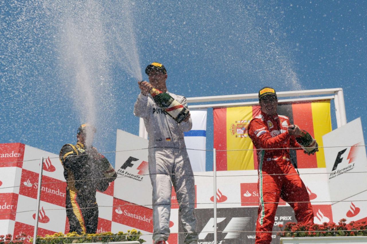 '(L to R) Second-placed Lotus F1 Team\'s Finnish driver Kimi Raikkonen, winner Ferrari\'s Spanish driver Fernando Alonso and third-placed Mercedes\' German driver Michael Schumacher celebrate on the p