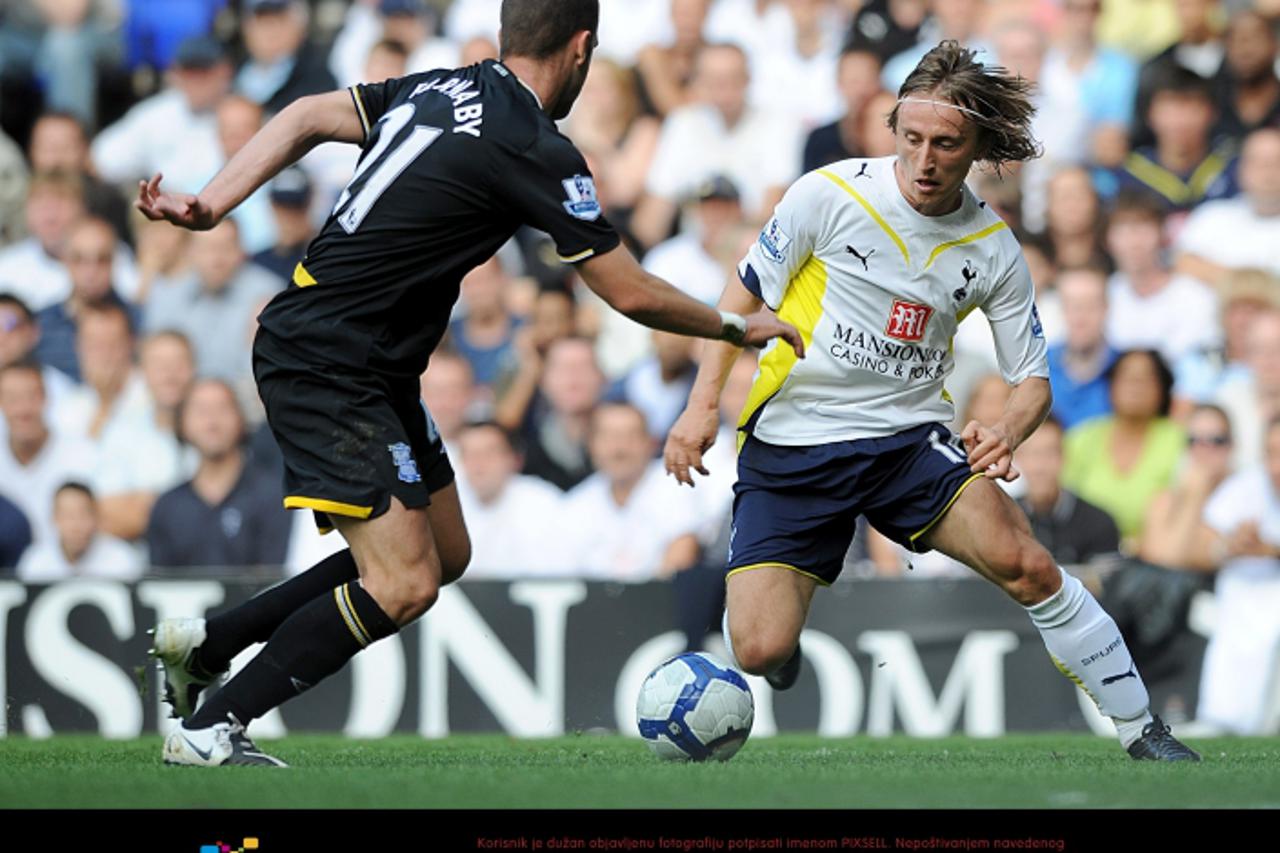 'Tottenham Hotspur\'s Luka Modric and Birmingham City\'s Stuart Parnaby (left) battle for the ball Photo: Press Association/Pixsell'