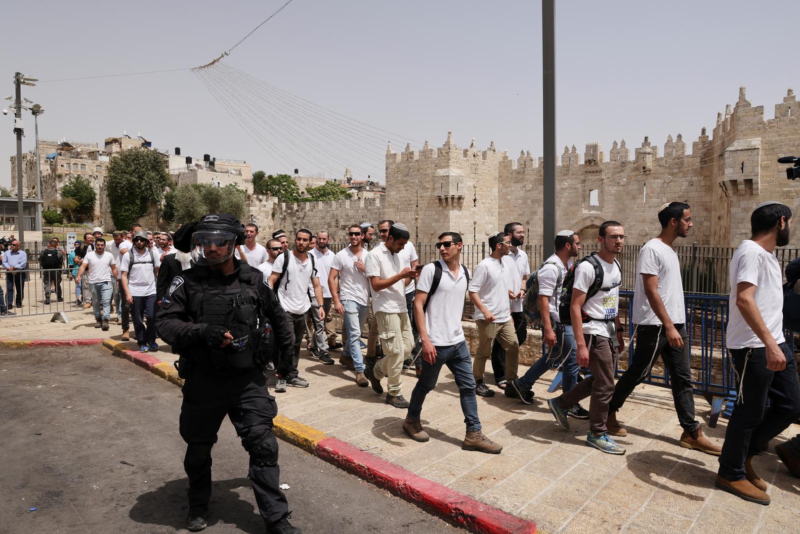 Violence flares at al-Aqsa mosque as Israel marks Jerusalem Day A member of the Israeli security forces patrols in front of a group of Israelis amid Israeli-Palestinian tension as Israel marks Jerusalem Day, near Damascus Gate just outside Jerusalem's Old City May 10, 2021. REUTERS/Ronen Zvulun RONEN ZVULUN