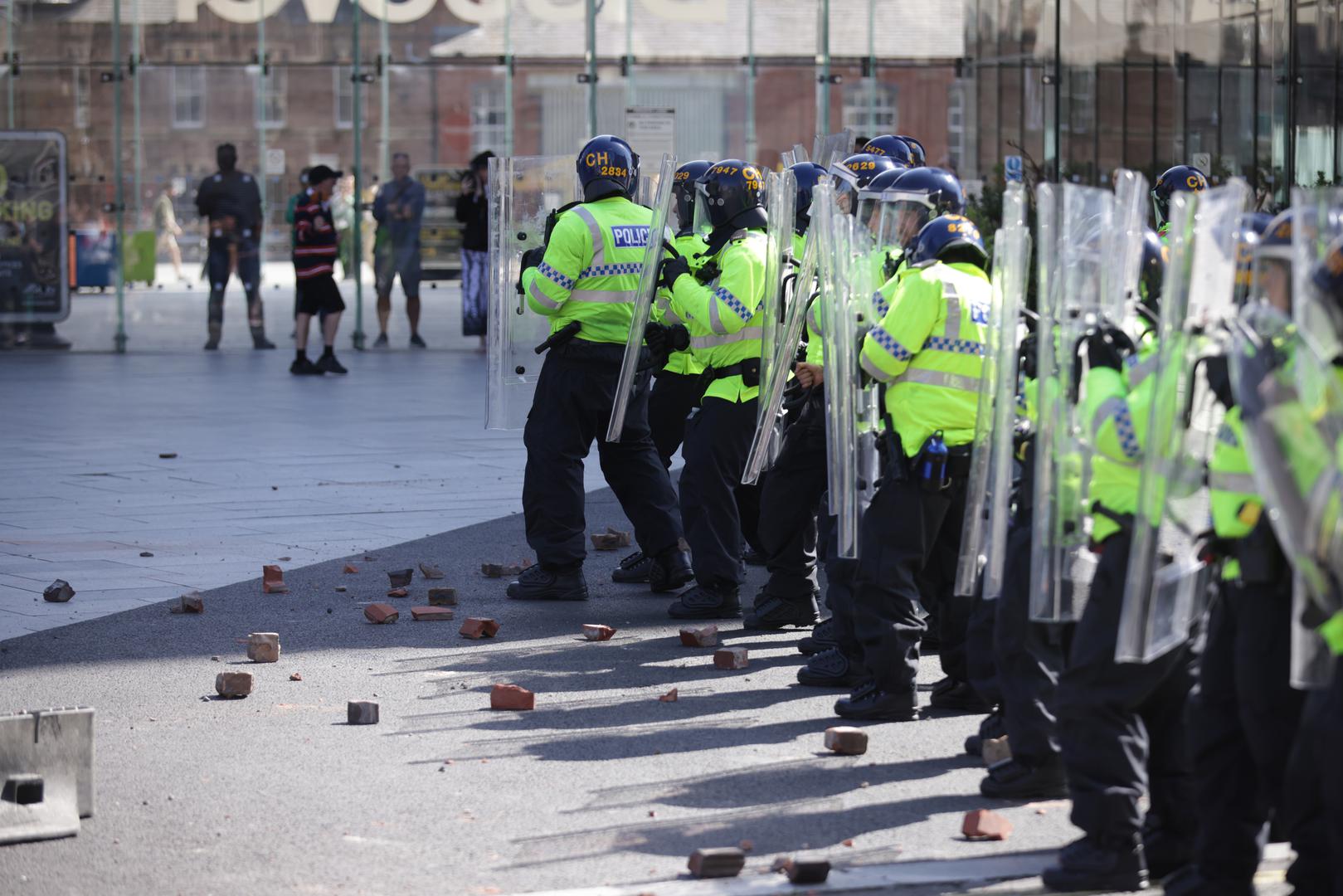 Rubble lies at the feet of police officers thrown by protesters in Liverpool, following the stabbing attacks on Monday in Southport, in which three young children were killed. Picture date: Saturday August 3, 2024. Photo: James Speakman/PRESS ASSOCIATION