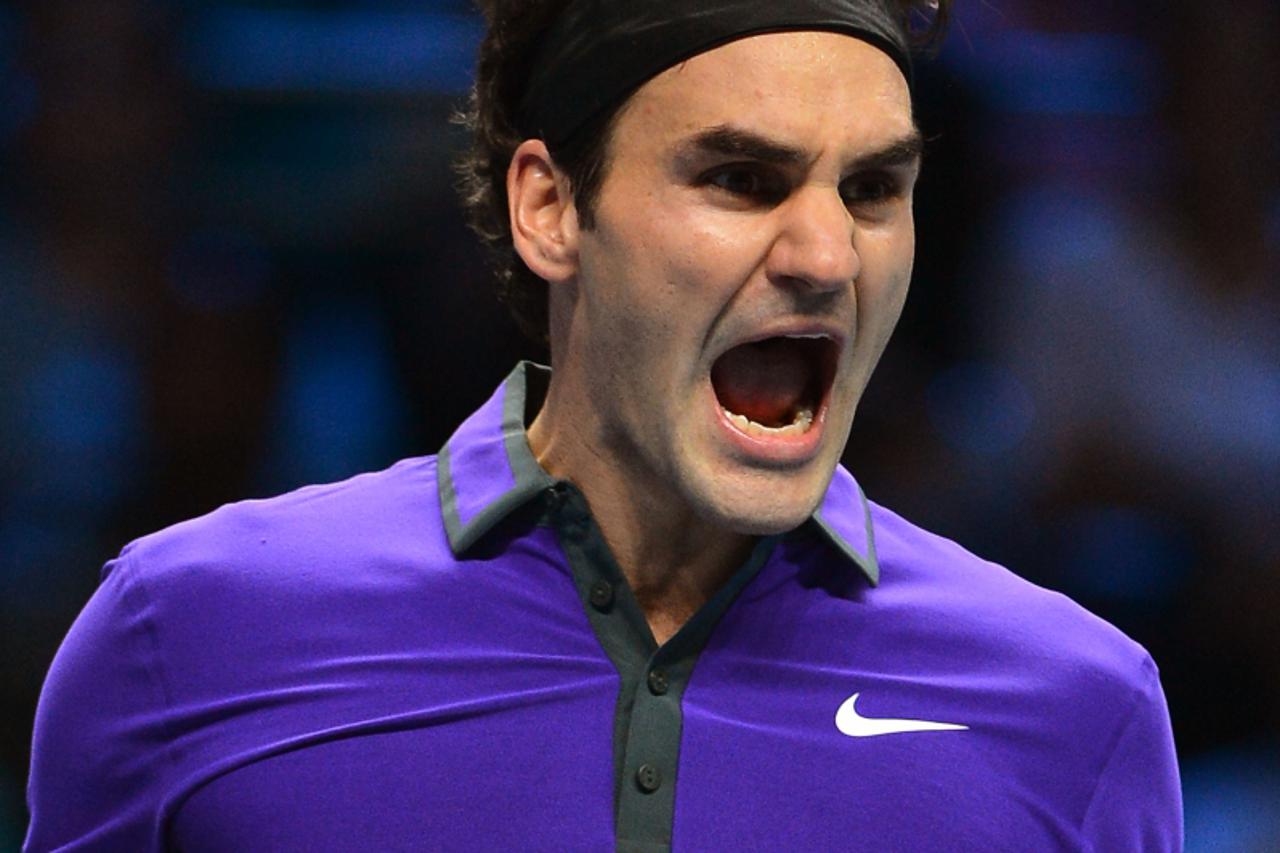 'Switzerland\'s Roger Federer celebrates beating Britain\'s Andy Murray in their semi-final singles match on the seventh day of the ATP World Tour Finals tennis tournament in London on November 11, 20