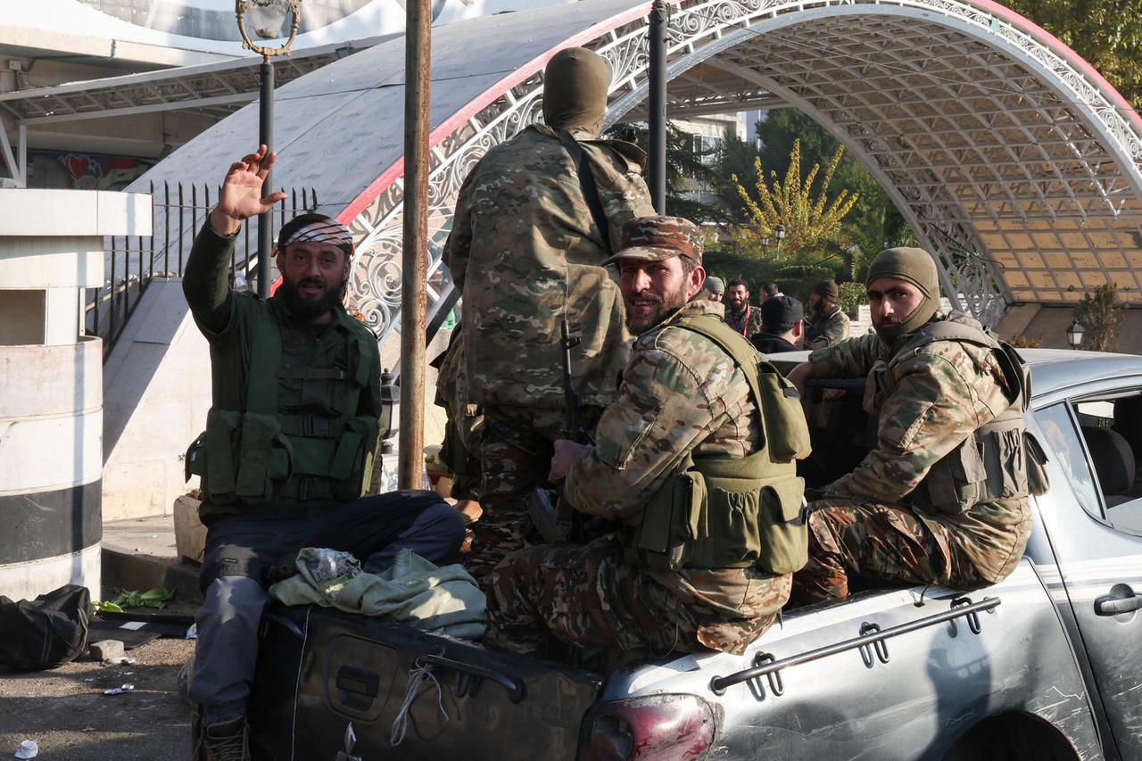 Rebel fighters ride on a truck,, in Damascus