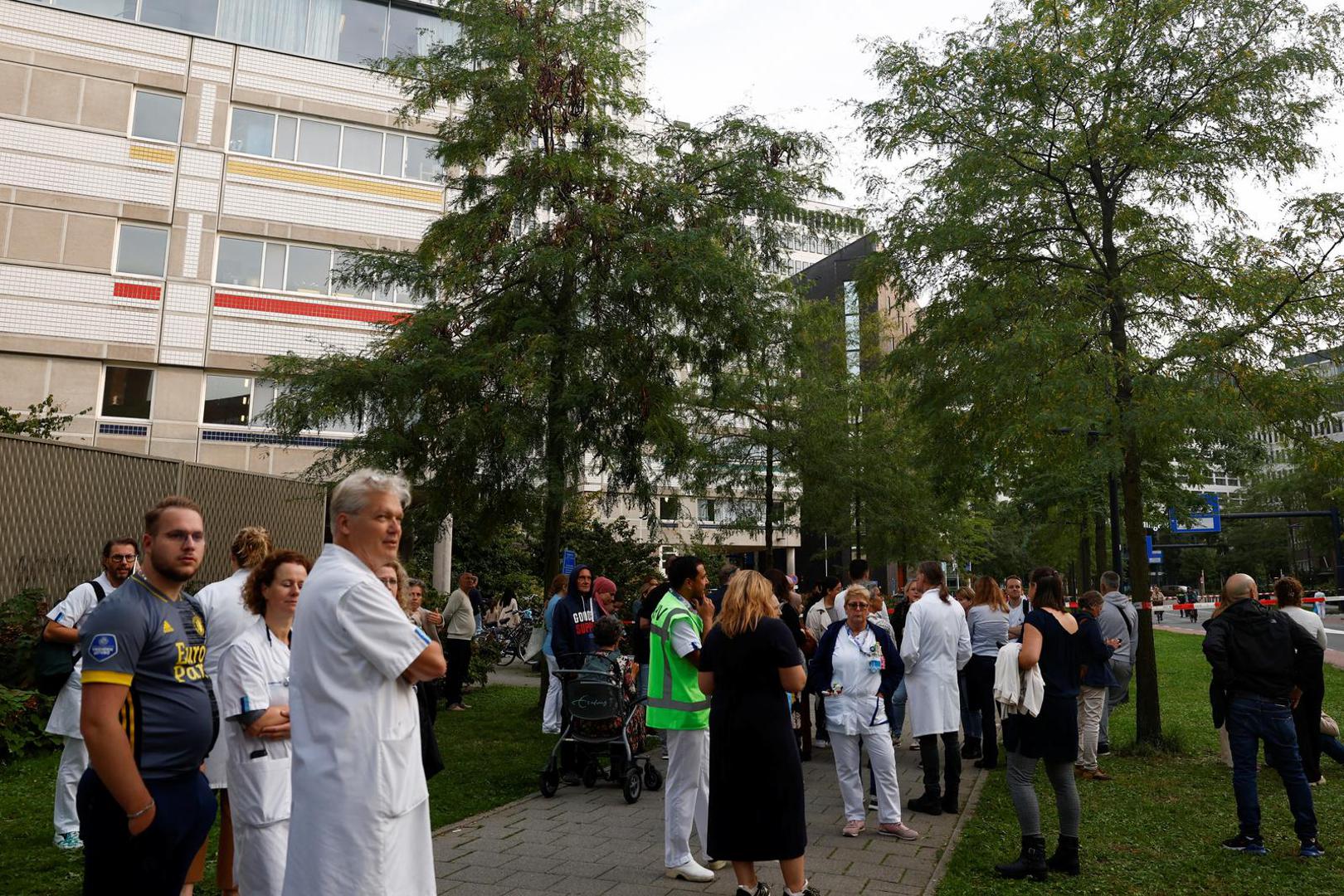 People stand on the sidewalk, near a medical center, after Dutch police arrested a suspect after a shooting in Rotterdam, Netherlands, September 28, 2023. REUTERS/Piroschka van de Wouw Photo: Piroschka van de Wouw/REUTERS