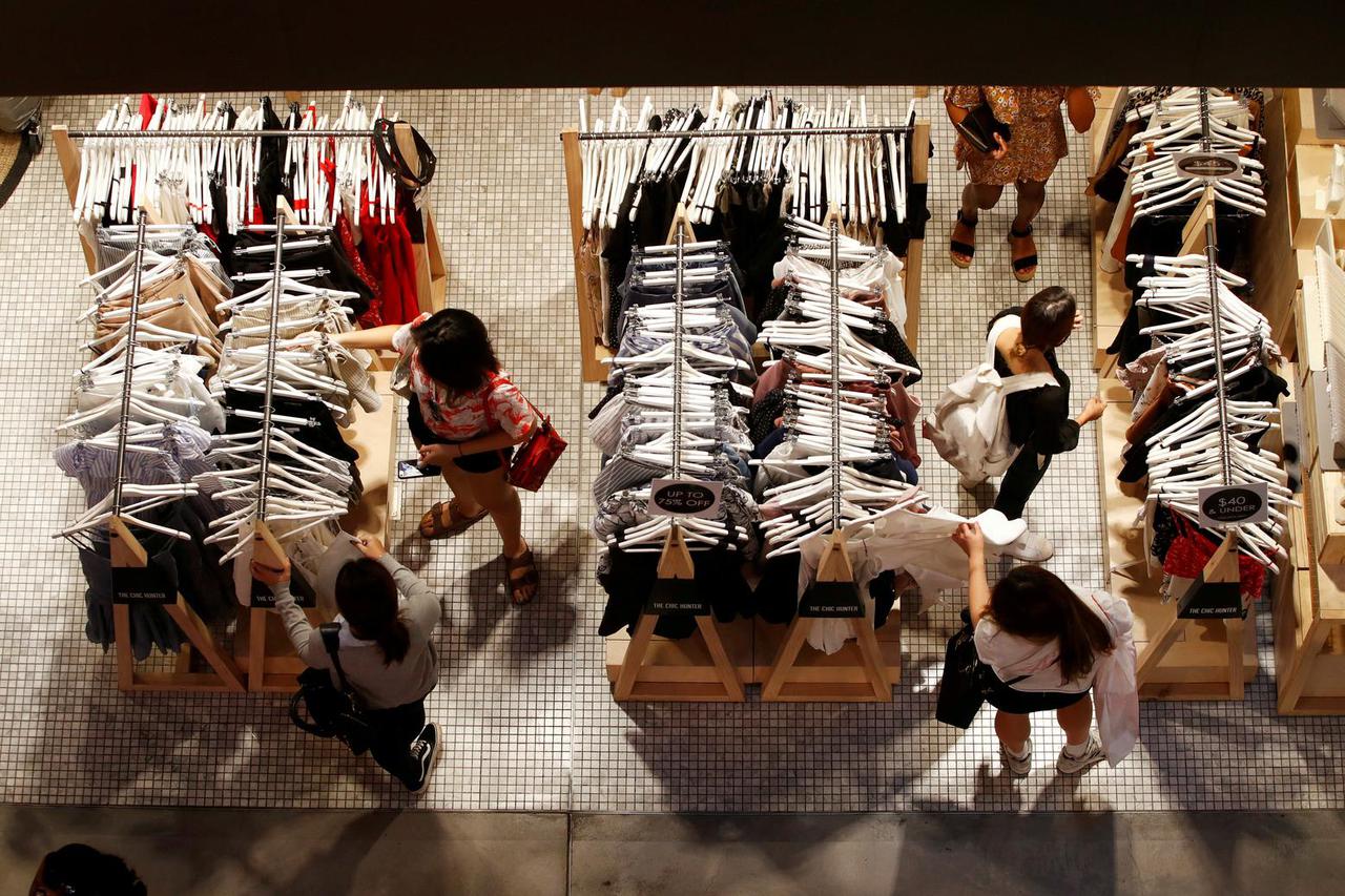 FILE PHOTO: Women shop for clothes on a store in a shopping mall in Sydney