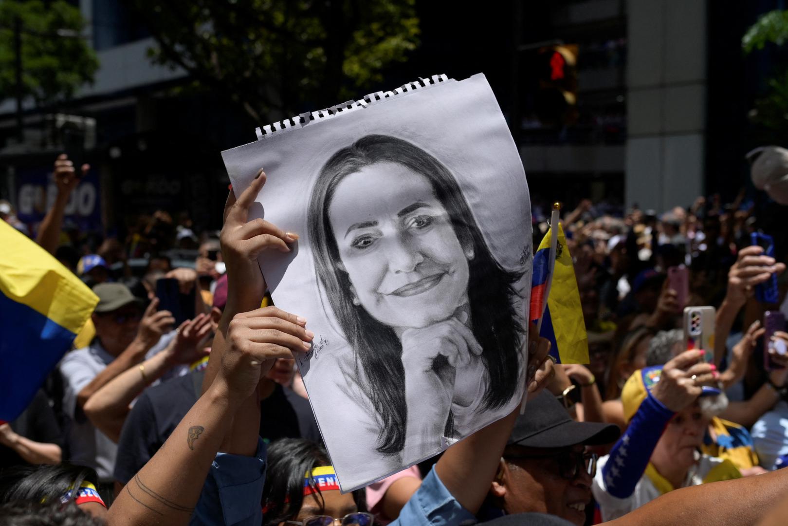 Supporters of Venezuelan opposition leader Maria Corina Machado hold up a portrait of her during a protest against the election results announced by Venezuelan President Nicolas Maduro's government after he was declared winner of the election, in Caracas, Venezuela, August 28, 2024. REUTERS/Maxwell Briceno Photo: Maxwell Briceno/REUTERS