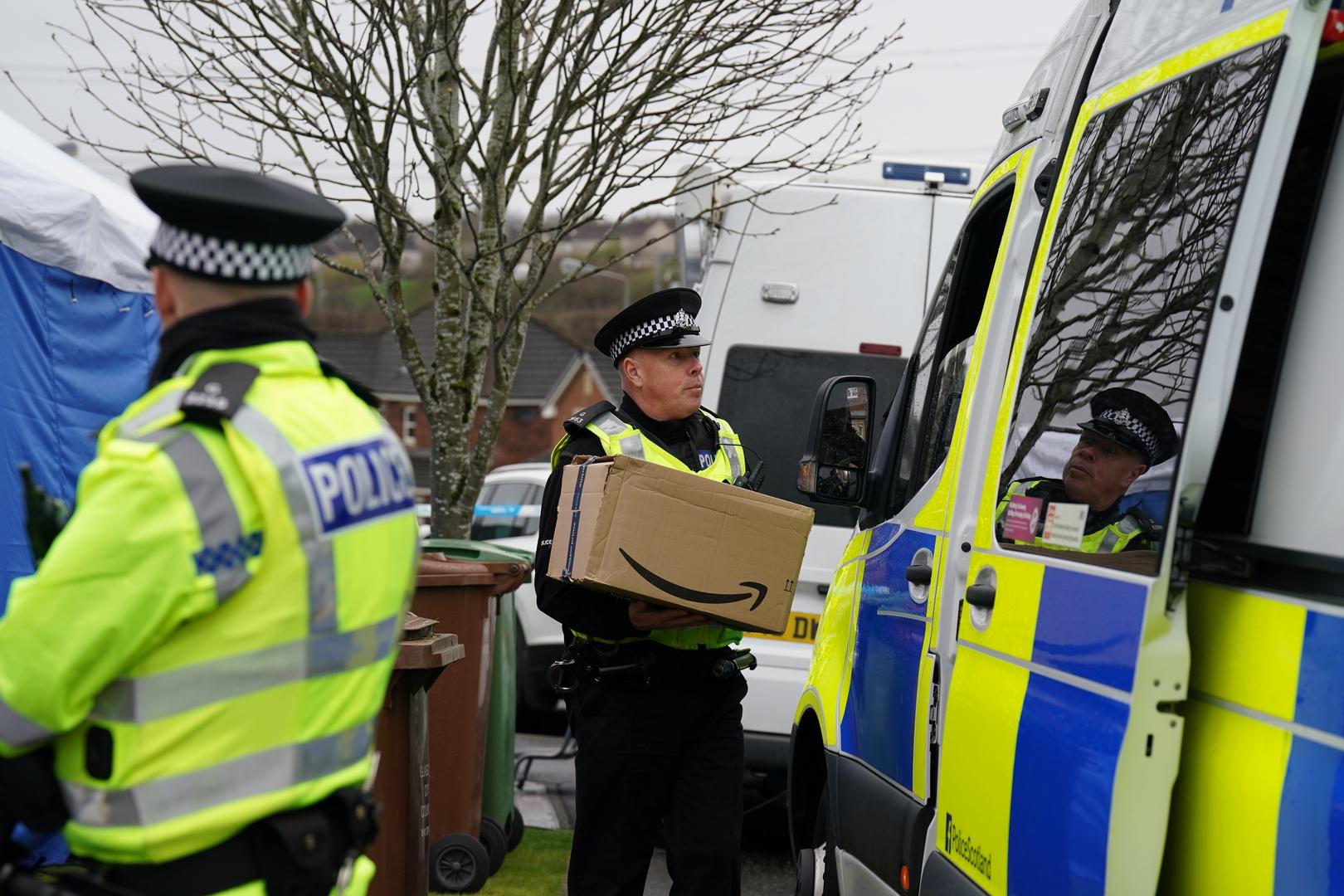 An officer from Police Scotland carries a parcel delivery into the home of former chief executive of the Scottish National Party (SNP) Peter Murrell, in Uddingston, Glasgow, after he was arrested in connection with the ongoing investigation into the funding and finances of the party. Picture date: Wednesday April 5, 2023. Photo: Andrew Milligan/PRESS ASSOCIATION