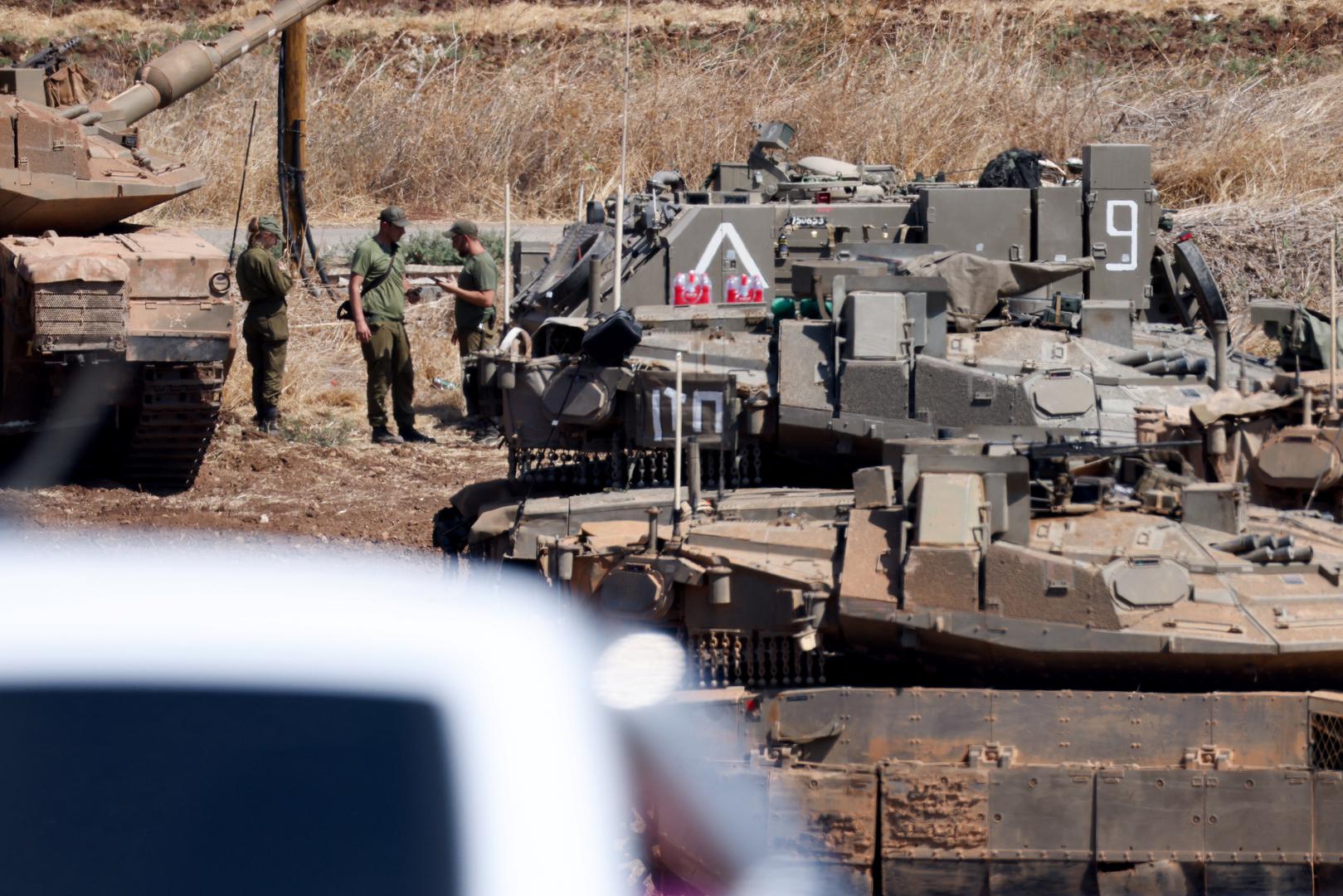 Israeli members of the military stand next to armoured vehicles, amid cross-border hostilities between Hezbollah and Israel, in northern Israel, September 30, 2024. REUTERS/Jim Urquhart Photo: JIM URQUHART/REUTERS