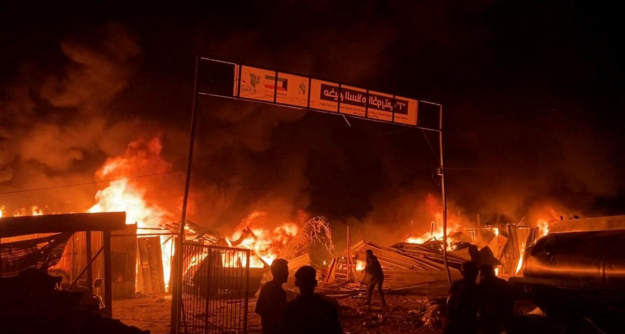 Fire rages following an Israeli strike on an area designated for displaced Palestinians, amid the ongoing conflict between Israel and Hamas, in Rafah in the southern Gaza Strip, in this still picture taken from a video, May 26, 2024. REUTERS/Reuters TV Photo: REUTERS TV/REUTERS