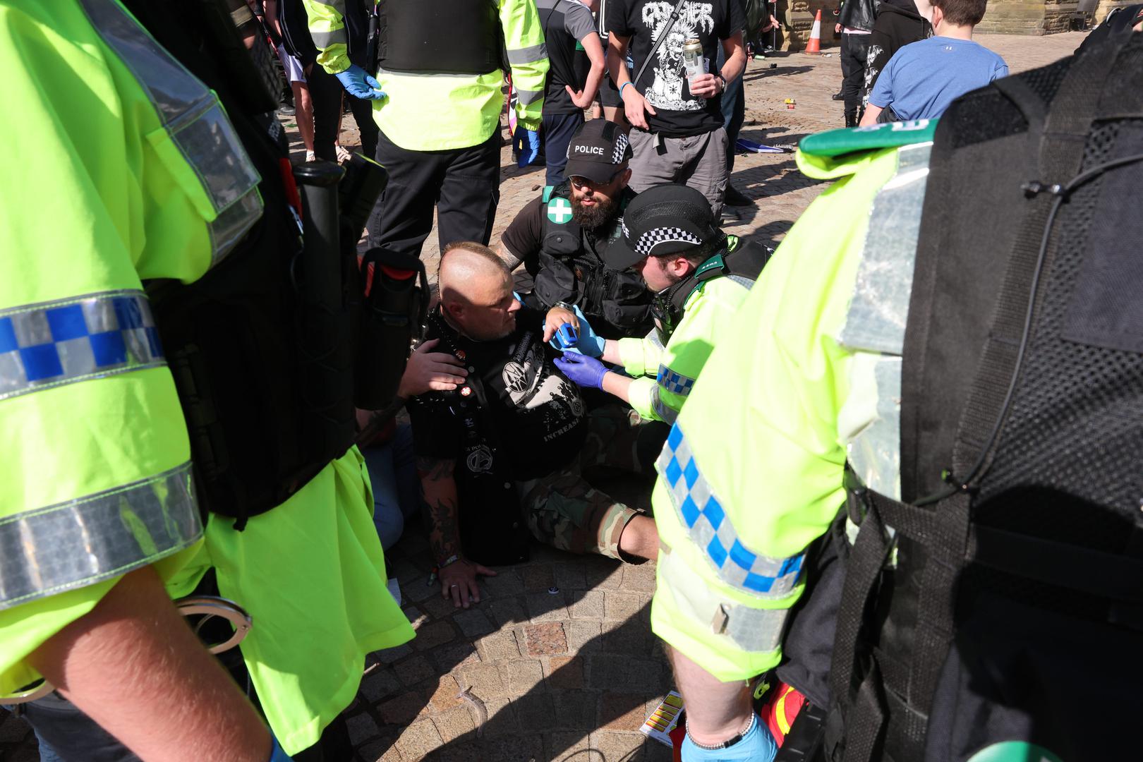 An injured man is tended to after a fight broke out between anti-fascists and other people protesting in Blackpool, following the stabbing attacks on Monday in Southport, in which three young children were killed. Picture date: Saturday August 3, 2024. Photo: Michael Holmes/PRESS ASSOCIATION