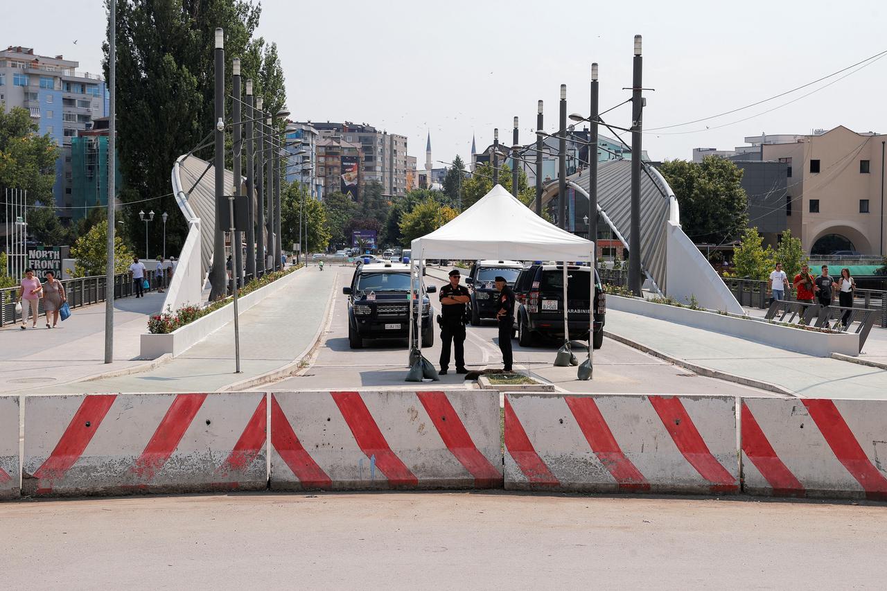 Members of Italy's Carabinieri, part of the NATO peacekeeping mission, patrol in Mitrovica