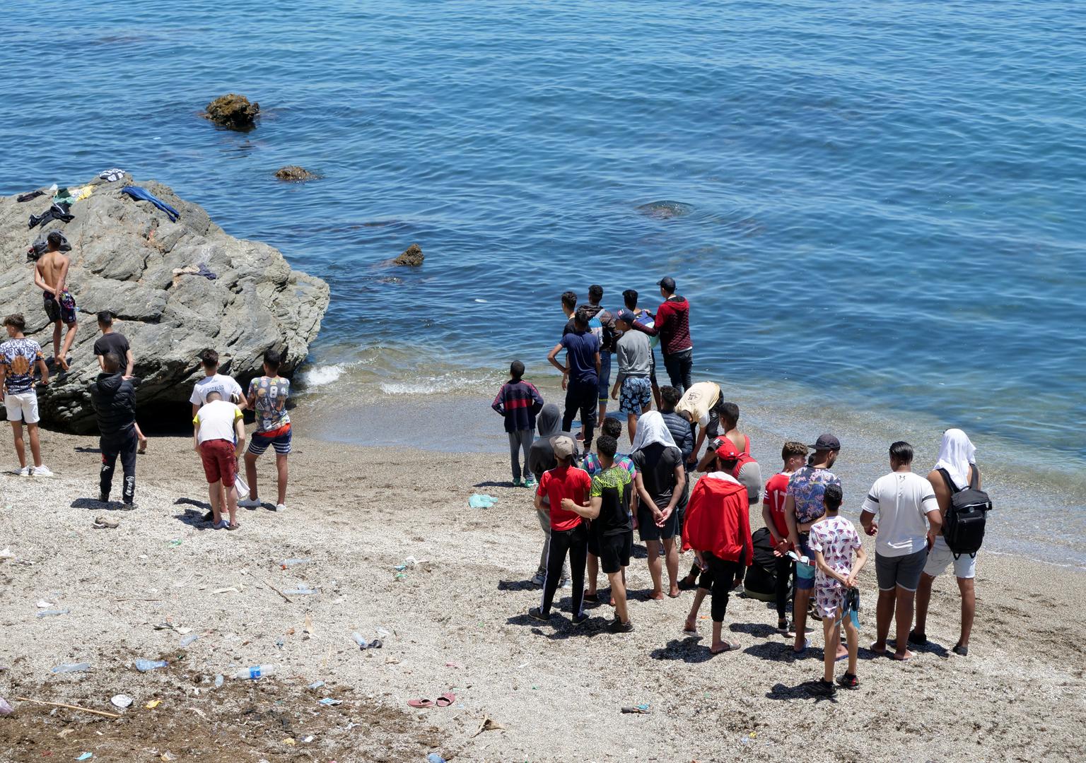 Migrant stand at the beach in Fnideq, close to the Spanish enclave Ceuta Migrant stand at the beach in Fnideq, close to the Spanish enclave Ceuta, in Morocco, May 19, 2021. REUTERS/Shereen Talaat SHEREEN TALAAT