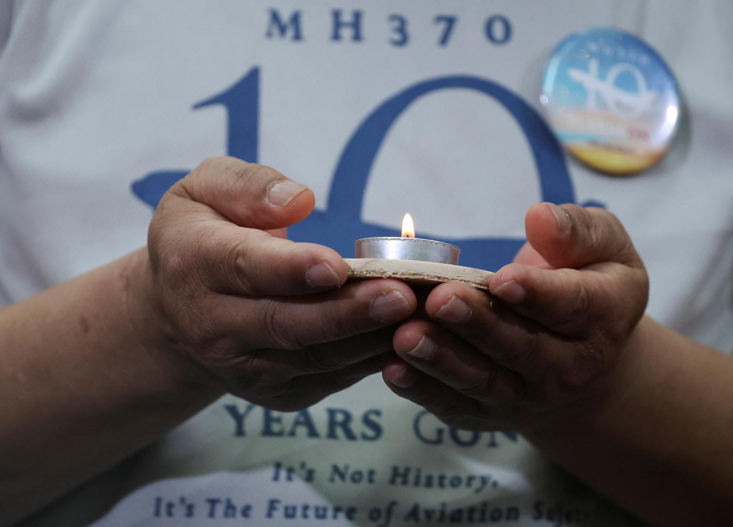 A family member of the missing Malaysia Airlines flight MH370 holds a candle during a remembrance event marking the 10th anniversary of its disappearance, in Subang Jaya, Malaysia March 3, 2024. REUTERS/Hasnoor Hussain Photo: HASNOOR HUSSAIN/REUTERS