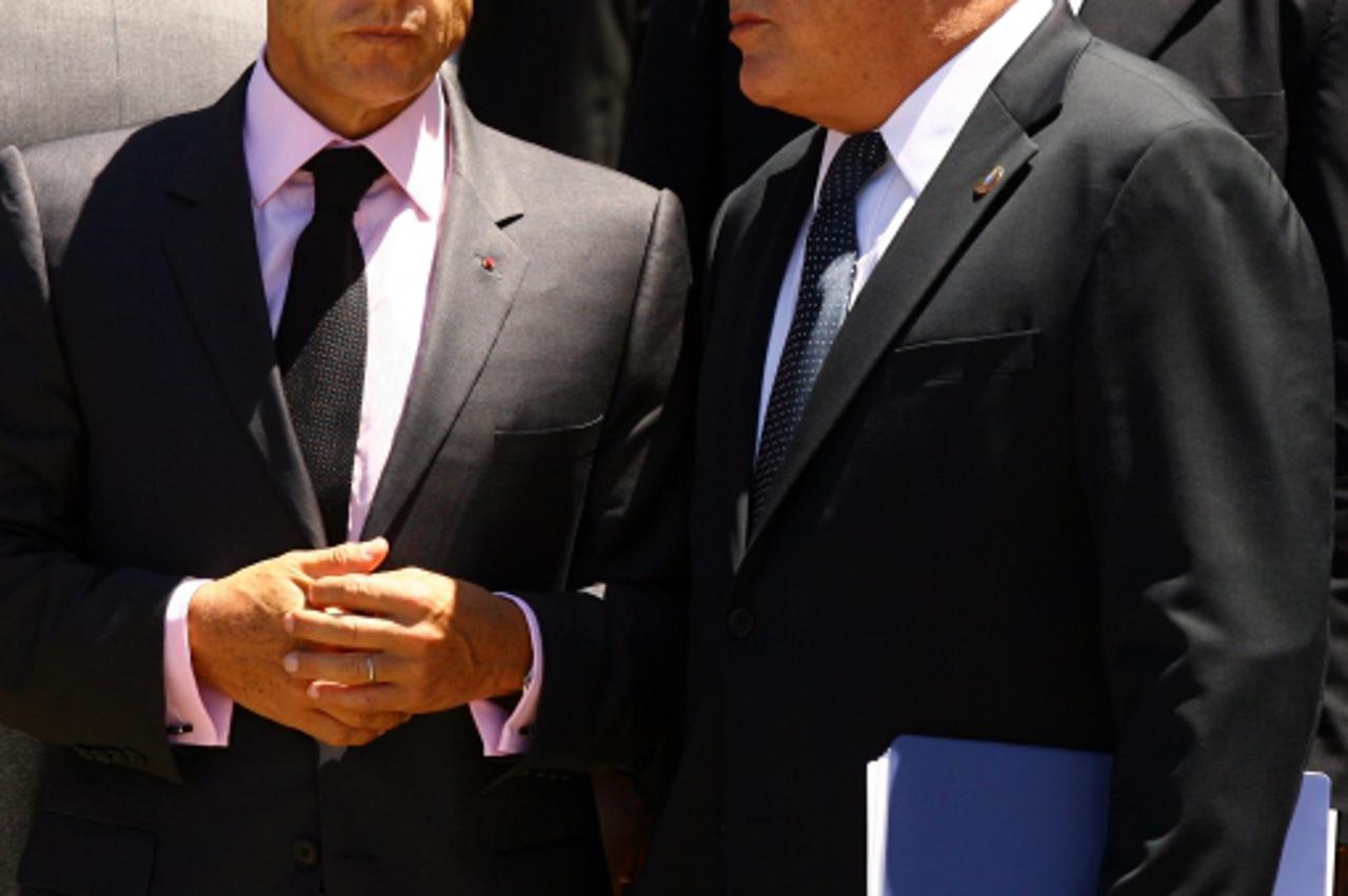 'French President Nicolas Sarkozy (left) chats to Dominique Strauss-Kahn, the Head of the IMF, prior to make his way to the stage where the leaders of the G8 nations and the G5 nations will pose for a