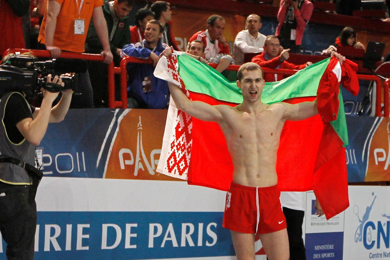 FILE PHOTO: Belarus's Krauchanka and Czech Republic's Sebrle react after the men's Heptathlon event at the European Athletics indoor championships in Paris