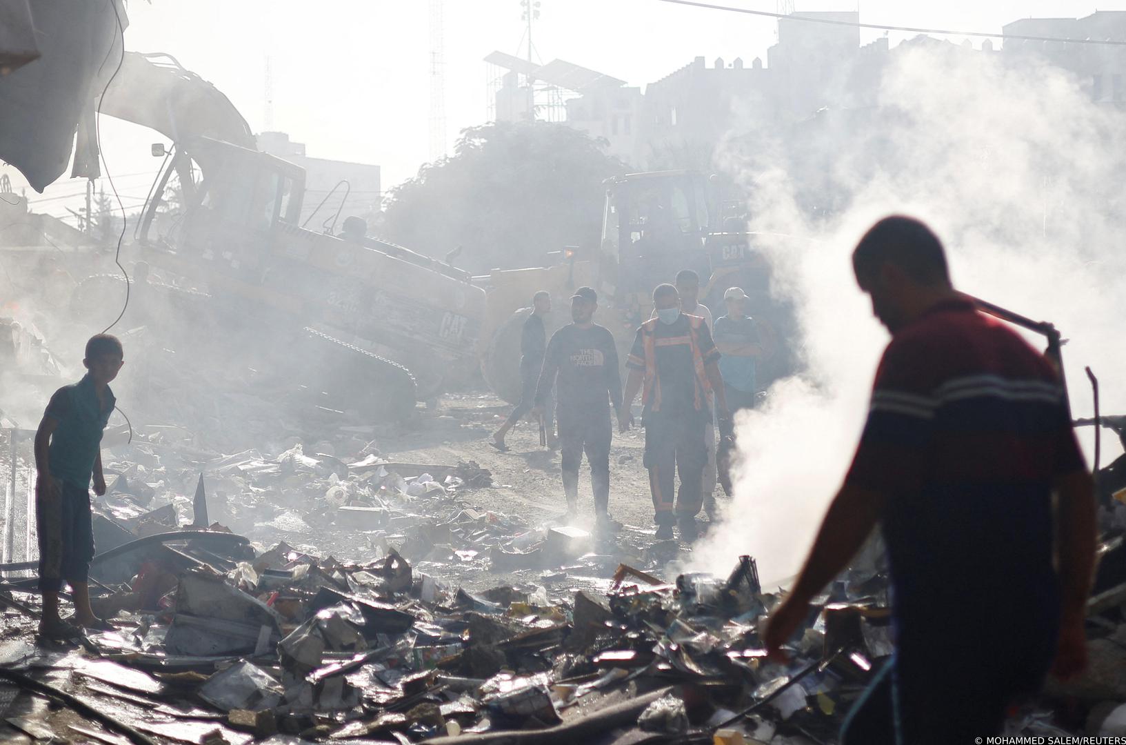 A Palestinian firefighter, along with others, walks at the site of Israeli strikes on a residential building, amid the ongoing conflict between Israel and Palestinian Islamist group Hamas, in Khan Younis in the southern Gaza Strip, November 7, 2023. REUTERS/Mohammed Salem Photo: MOHAMMED SALEM/REUTERS