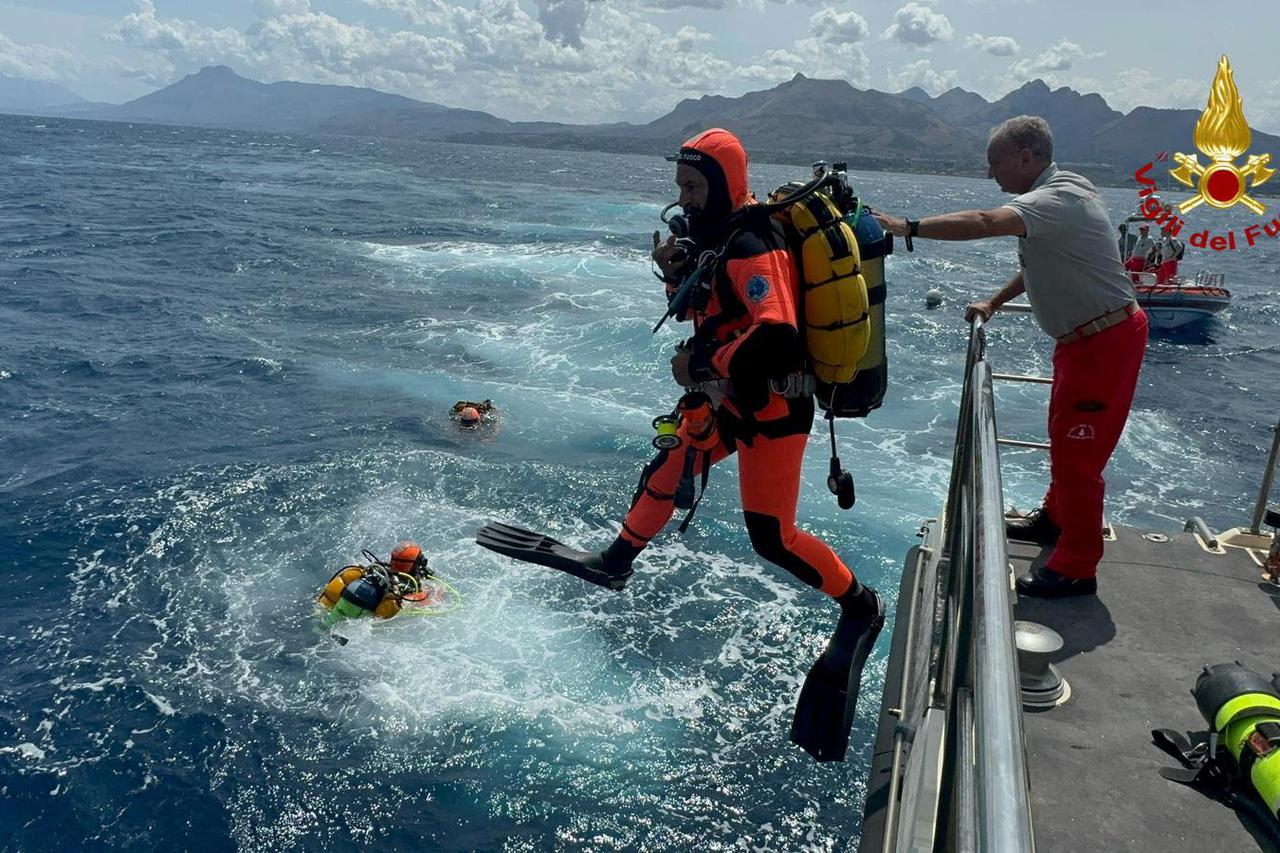 Divers operate in the sea to search for the missing after a luxury yacht sank off Sicily