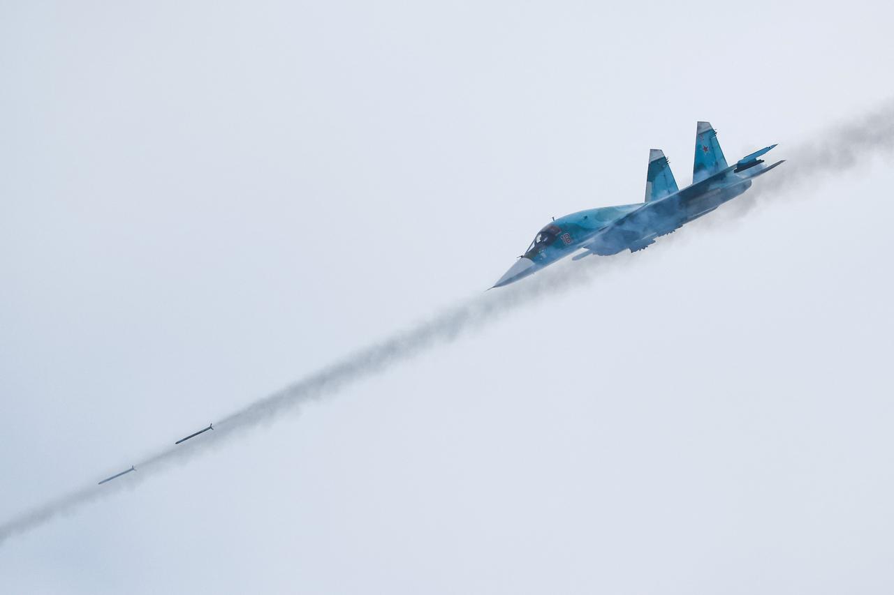 FILE PHOTO: A Russian Sukhoi Su-34 fighter-bomber fires missiles during the Aviadarts competition outside Ryazan