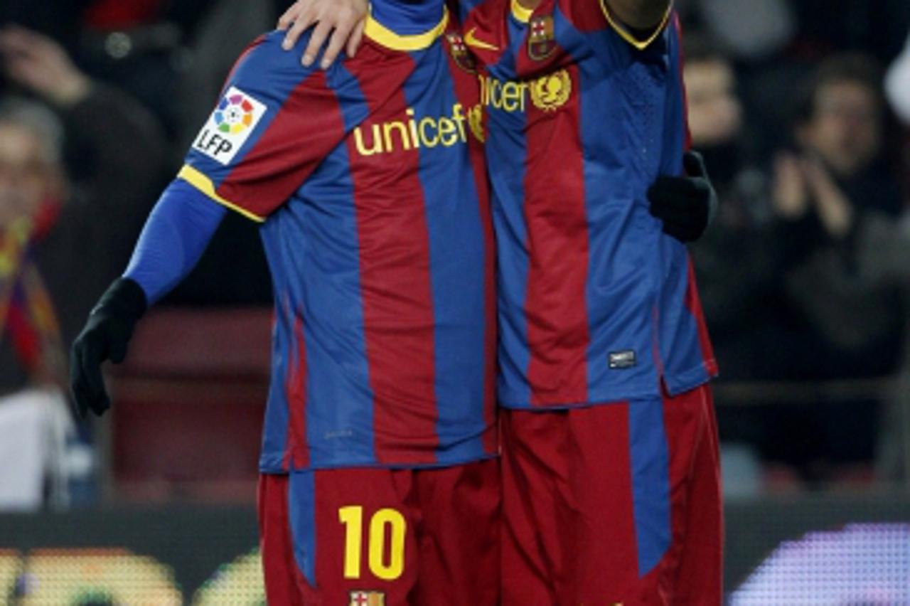 'Barcelona\'s soccer players Lionel Messi (L) and David Villa celebrate a goal against Almeria during their Spanish King\'s Cup semi-final soccer match at Camp Nou stadium in Barcelona January 26, 201