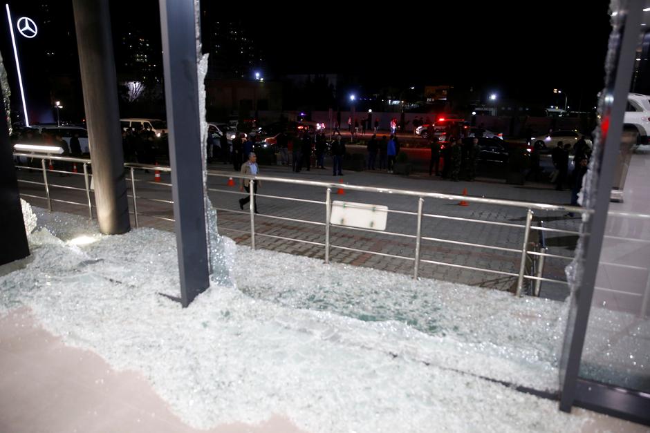 Broken glass is seen at the Bright Castle Motors building after reports of mortar shells landing near Erbil airport