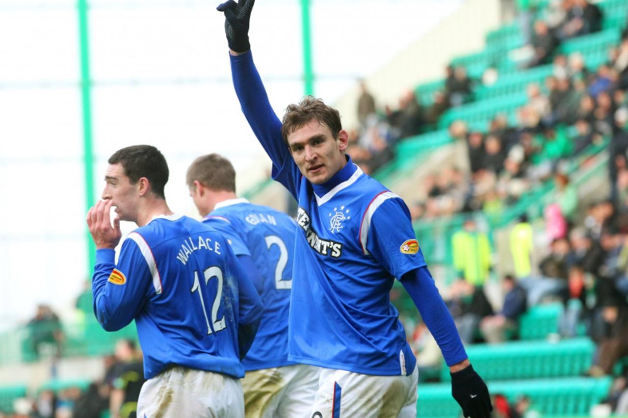 'Rangers\' Nikica Jelavic celebrates scoring his second goal against Hibernian during their Scottish Premier League soccer match in Edinburgh, Scotland December 10, 2011. REUTERS/David Moir (BRITAIN -