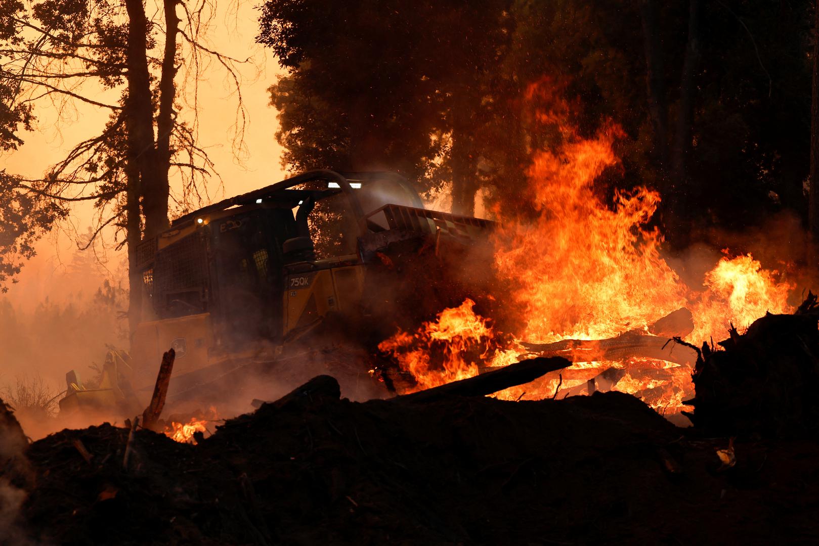 A bulldozer is used to put out flames off Highway 32 near Forest Ranch, California, U.S. July 26, 2024. REUTERS/Fred Greaves Photo: FRED GREAVES/REUTERS